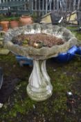 A LARGE WEATHERED COMPOSITE BIRD BATH, on a spiral base, diameter 89cm x height 64cm (condition