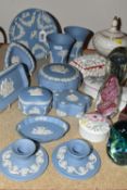 A COLLECTION OF WEDGWOOD BLUE JASPERWARE AND GLASS PAPERWEIGHTS, comprising a small cabinet plate, a
