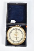A CASED COMPENSATED HANGING ANEROID BAROMETER, this is made of brass and has a white dial with black