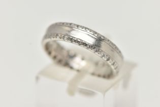 A PLATINUM AND DIAMOND BAND RING, a central polished band with diamond set edges, approximately 58