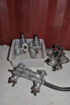 FOUR SU CARBURETTORS AND AN INTAKE MANIFOLD. carbs stamped AUC1341 and 1342 and AUC870 and 872