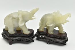 A PAIR OF MODERN CARVED JADE ELEPHANT FIGURINES, each with a molded wooden plinth, approximate