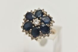 A LARGE 18CT GOLD SAPPHIRE AND DIAMOND CLUSTER RING, six oval cut sapphires and a central round