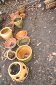 A COLLECTION OF SEVENTEEN TERRACOTTA PLANT POTS AND PLANTERS including a rhubarb forced, two 26cm