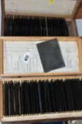 TWO BOXES OF GLASS PHOTOGRAPHIC NEGATIVE SLIDES (approx. 10.7cm x 8.2cm) containing 100 slides