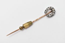 A LATE VICTORIAN DIAMOND HORSE SHOE STICK PIN, set with mainly old cut diamonds, estimated total