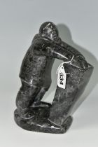 A CANADIAN INUIT SOAPSTONE CARVING, of an Inuit fisherman, height approx. 20cm, inscribed marks to