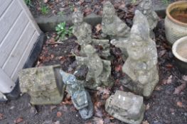 A COLLECTION OF MODERN COMPOSITE GARDEN GNOMES AND COTTAGES including a cobbler( missing its hammer)