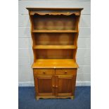 A MODERN PINE DRESSER, the top two tier plate rack, on a base fitted with two drawers and two