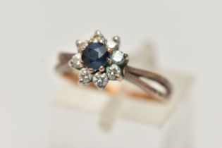 AN 18CT SAPPHIRE AND DIAMOND CLUSTER RING, the central circular sapphire within a brilliant cut