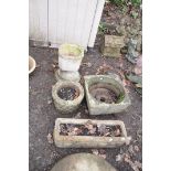 FOUR MODERN COMPOSITE GARDEN PLANTERS including an oblong and a circular planter with brickwork