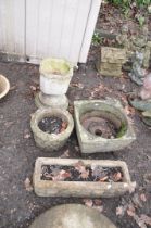 FOUR MODERN COMPOSITE GARDEN PLANTERS including an oblong and a circular planter with brickwork