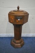 A 20TH CENTURY OAK OCTAGONAL BAPTISMAL FONT, the removable lid, raised on a pillar and stepped base,