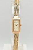 A LADY'S 9CT GOLD ACCURIST WRISTWATCH, the rectangular cream face with gold colour baton markers and