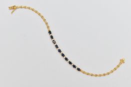 A SAPPHIRE AND DIAMOND BRACELET, designed as a central section of ten oval cut sapphires interspaced