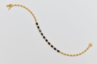 A SAPPHIRE AND DIAMOND BRACELET, designed as a central section of ten oval cut sapphires interspaced