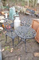 A MODERN CAST ALUMINIUM ROUND GARDEN TABLE AND TWO CHAIRS with pierced detail to seat and 60cm