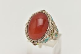 A WHITE METAL CARNELIAN AND ENAMEL DRESS RING, large oval carnelian cabochon, collet set to the fine