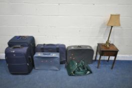 FIVE VARIOUS SUITCASES, a green Jaguar carry back, a 20th century oak sewing box and a table lamp (