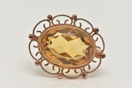 A 9CT GOLD CITRINE BROOCH, of an oval form, set with a large oval cut citrine, in a milgrain