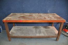 A BESPOKE WORKSHOP TABLE/BENCH constructed from painted pine frame, plywood top and hardboard