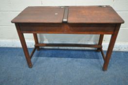 A KINGFISHER STAINED BEECH TWIN SCHOOL DESK, with two inkwell and two hinged storage compartments,
