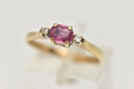 A 9CT GOLD RUBY AND DIAMOND RING, designed as a central oval shape ruby flanked by single cut