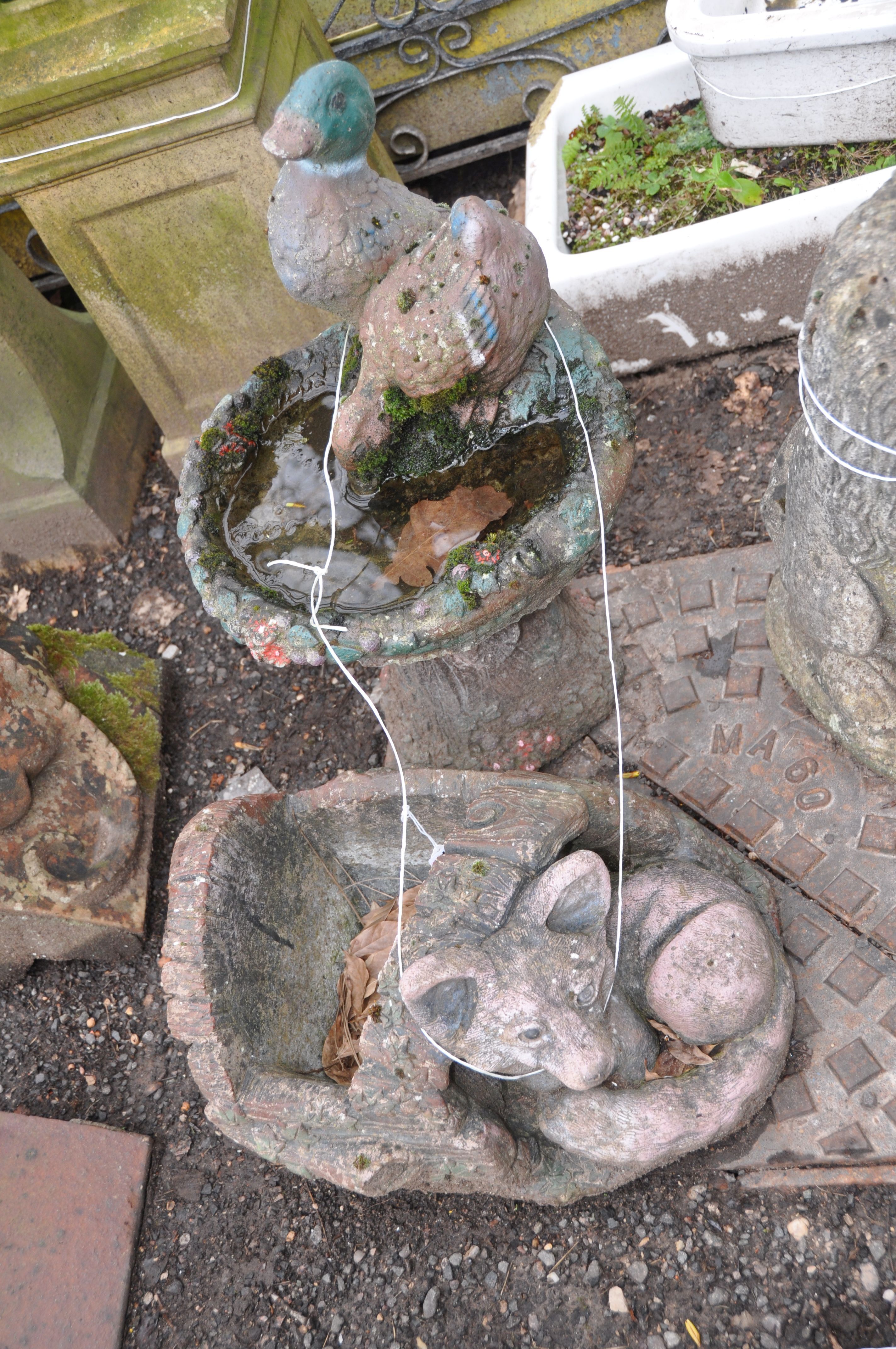 A MODERN COMPOSITE BIRDBATH in the form of two ducks drinking from a tree stump in two pieces height