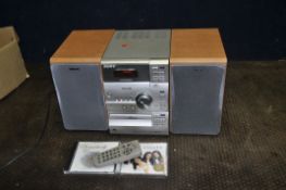 A SONY CMT-CP11 MINI HI FI with remote, two matching speakers and two CDs (PAT pass and working