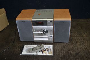 A SONY CMT-CP11 MINI HI FI with remote, two matching speakers and two CDs (PAT pass and working