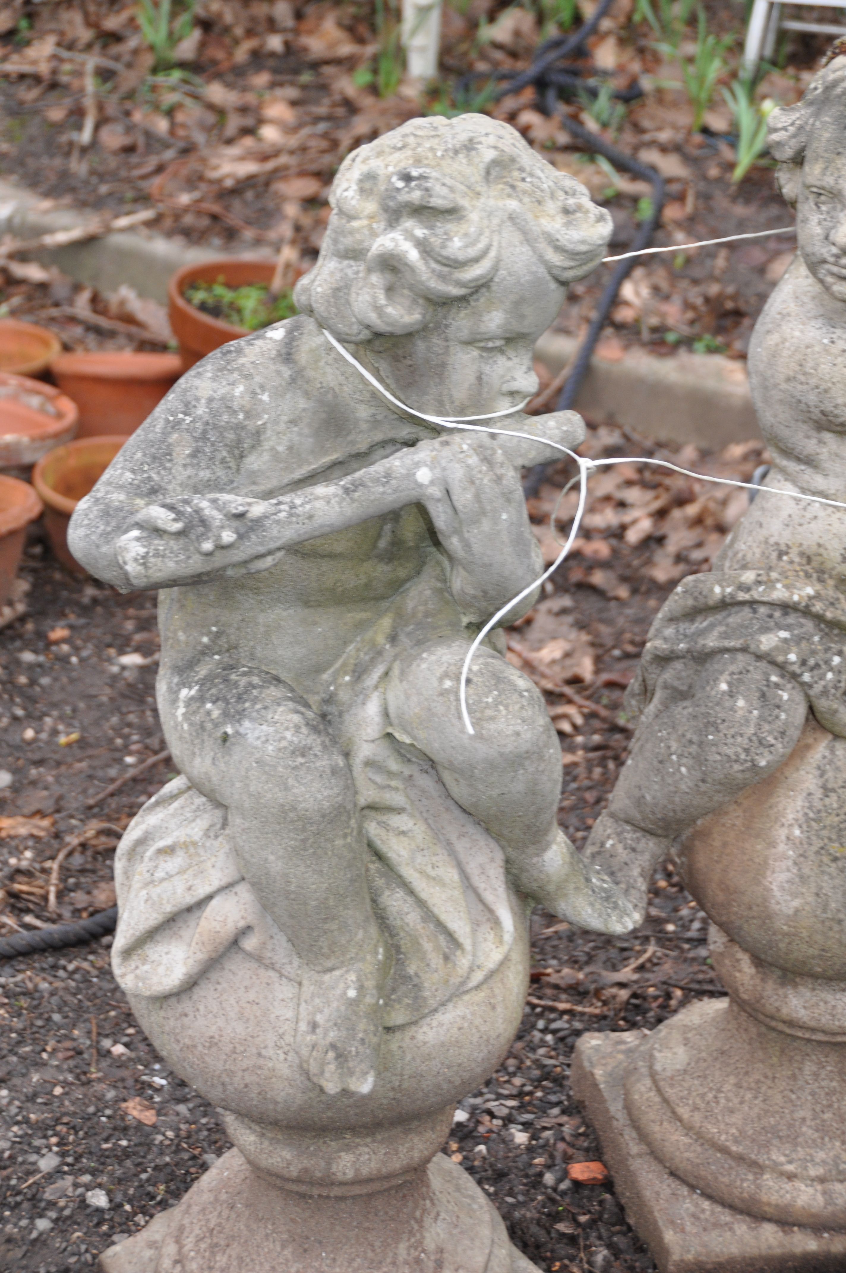 A SET OF THREE MOULDED GARDEN FIGURES IN THE FORM OF CHILDREN EACH PLAYING A MUSICAL INSTRUMENT - Image 2 of 4