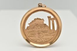 A LARGE YELLOW METAL PENDANT, of a circular form, depicting the Acropolis of Athens, approximate