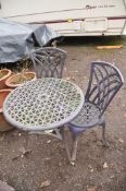 A CAST ALUMINIUM THREE PIECE GARDEN SET with a 67cm diameter round table and two chairs all with