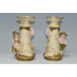 A PAIR OF ROYAL DUX FIGURAL VASES, comprising a young shepherd boy and goat on one vase, the other