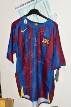 A SIGNED BARCELONA HOME REPLICA FOOTBALL SHIRT, signed by Ronaldinho, Eto'o, Puyol, Deco, Valdes,