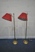 A PAIR OF LAURA ASHLEY BRASS STANDARD LAMPS, with shaped neck and red pleated shades, height