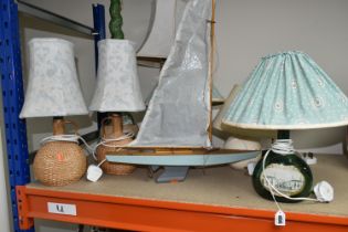 A SMALL MID- CENTURY POND YACHT AND A COLLECTION OF TABLE LAMPS, comprising hand painted wooden