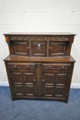 A 20TH CENTURY OAK COURT CUPBOARD, with repeating arched details, two doors, above two drawers and