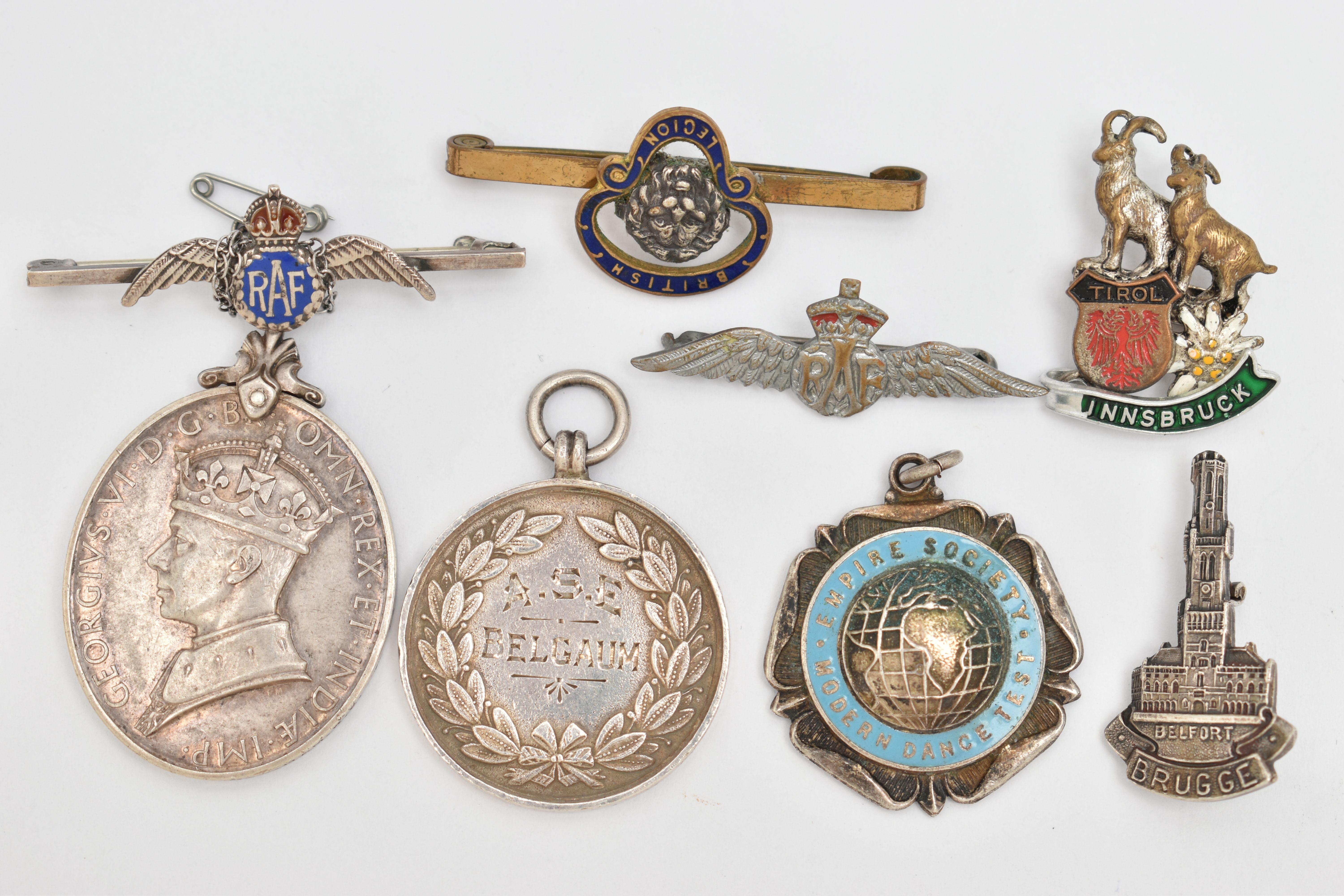 A SELECTION OF MEDALS AND BROOCHES, to include a George VI medal 'For Efficient Service,' edge