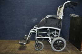 A DRIVE MEDICAL ENIGMA FOLDING WHEELCHAIR with two footrests
