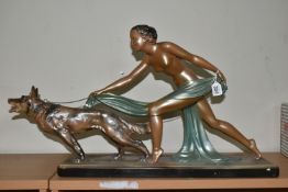 A LARGE ART DECO PATINATED PLASTER SCULPTURE, a figure of a nude female and Alsatian dog, width