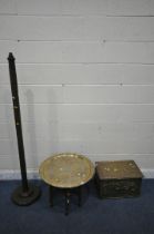 AN ISLAMIC ENGRAVED BRASS TRAY TABLE, on a folding wooden base, with mother of pearl inlay, diameter