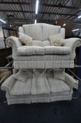 WADE UPHOLSTERY, A BEIGE UPHOLSTERED TWO PIECE LOUNGE SUITE, comprising a three seater sofa, along