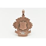 A LATE VICTORIAN 9CT GOLD FOB MEDAL, rose gold, wavy floral shape with a central engraved shield