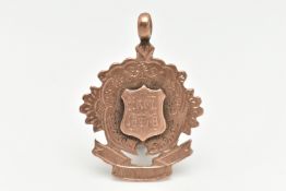 A LATE VICTORIAN 9CT GOLD FOB MEDAL, rose gold, wavy floral shape with a central engraved shield