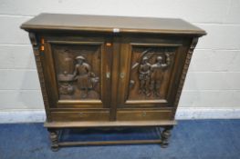 A 20TH CENTURY OAK CABINET, with two cupboard doors, carved with men in two different settings,