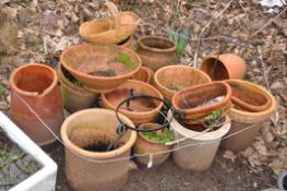 A COLLECTION OF MODERN TERRACOTTA PLANT POTS AND A VINTAGE CHIMNEY POT the largest pot being 47cm