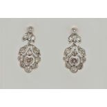 A PAIR OF WHITE METAL, DIAMOND DROP EARRINGS, each earring set with a central round brilliant cut