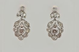 A PAIR OF WHITE METAL, DIAMOND DROP EARRINGS, each earring set with a central round brilliant cut