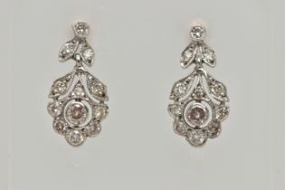 A PAIR OF WHITE METAL, DIAMOND DROP EARRINGS, each earring set with a central round brilliant cut